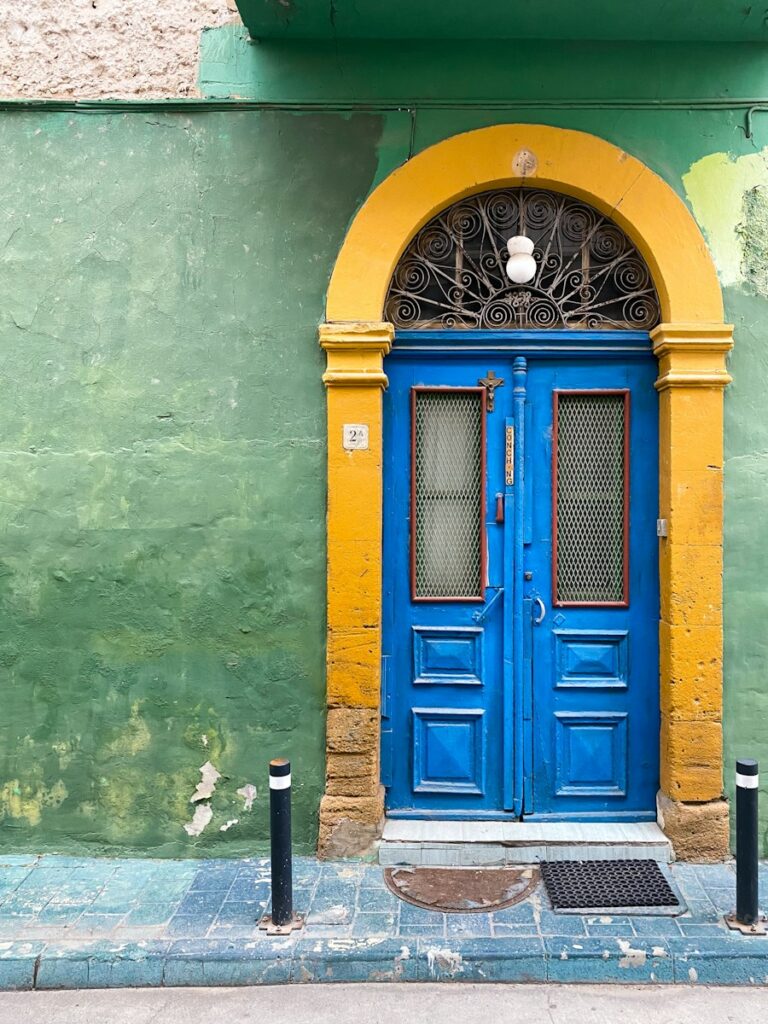 a blue and yellow door on a green building